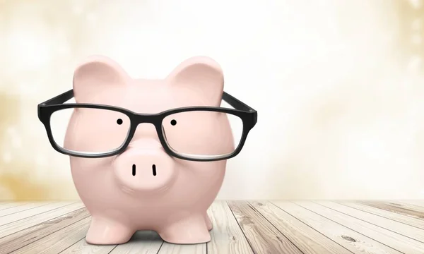 Piggy bank in glasses — Stock Photo, Image