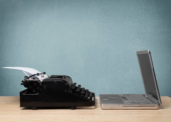 Modern laptop and typing machine