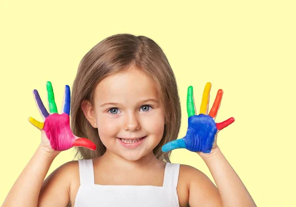 Little girl showing painted hands — Stock Photo, Image