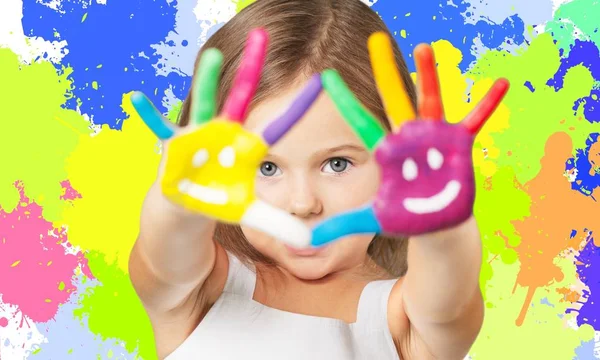 Little girl showing painted hands — Stock Photo, Image