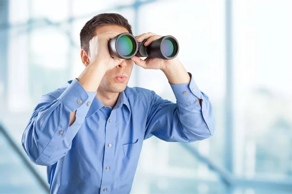 Businessman looking in binoculars — Stock Photo, Image