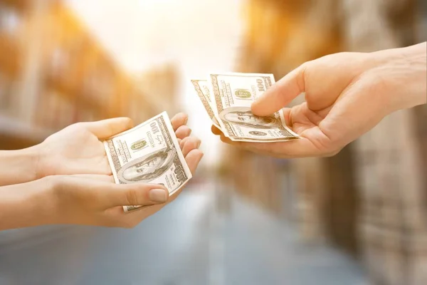 Giving hands with dollars — Stock Photo, Image