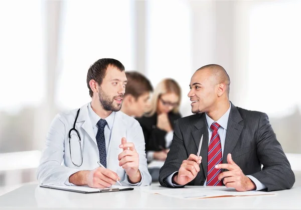 Doctor smiling with male patient