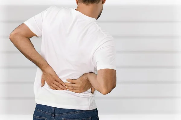 Young man with pain in back — Stock Photo, Image