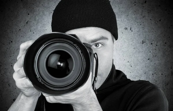 Photographer looking through camera Royalty Free Stock Images