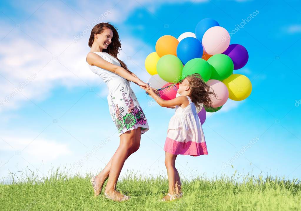 woman with girl and air balloons