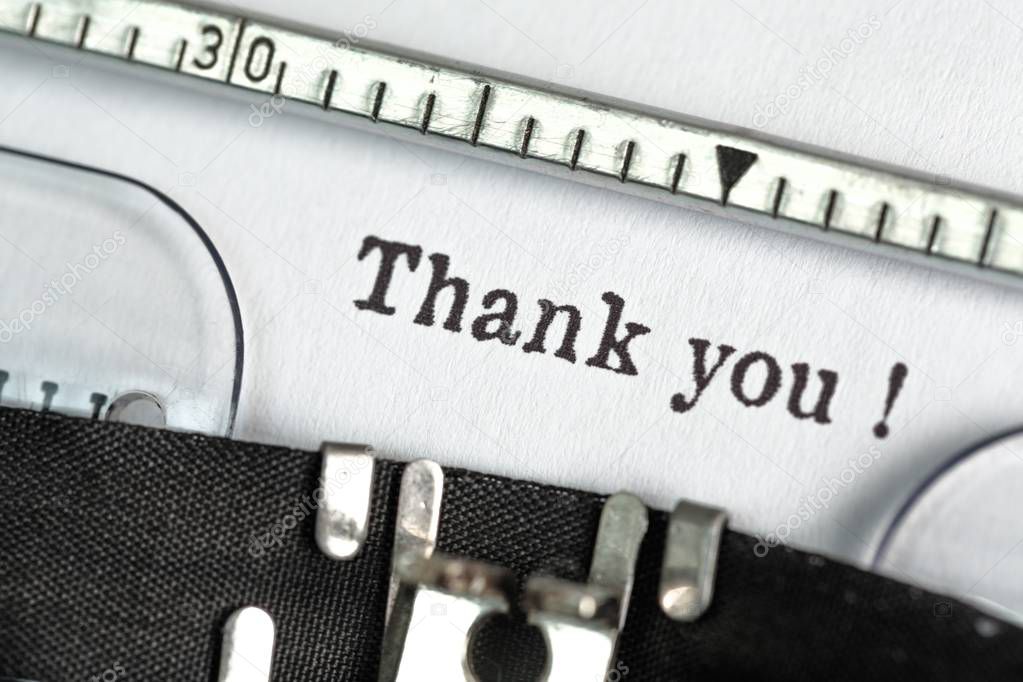 Old typewriter with paper with thank you on background 