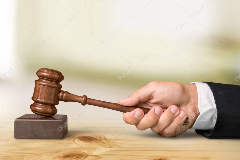 Wooden gavel in hand