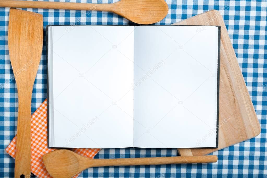 recipe notebook, spoons on  background