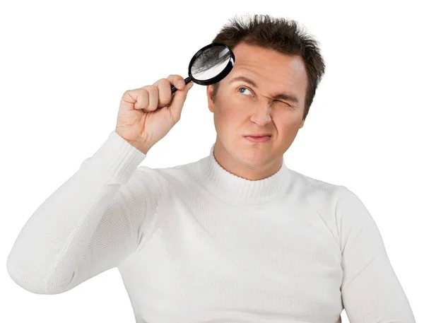 Young businessman with magnifying glass — Stock Photo, Image