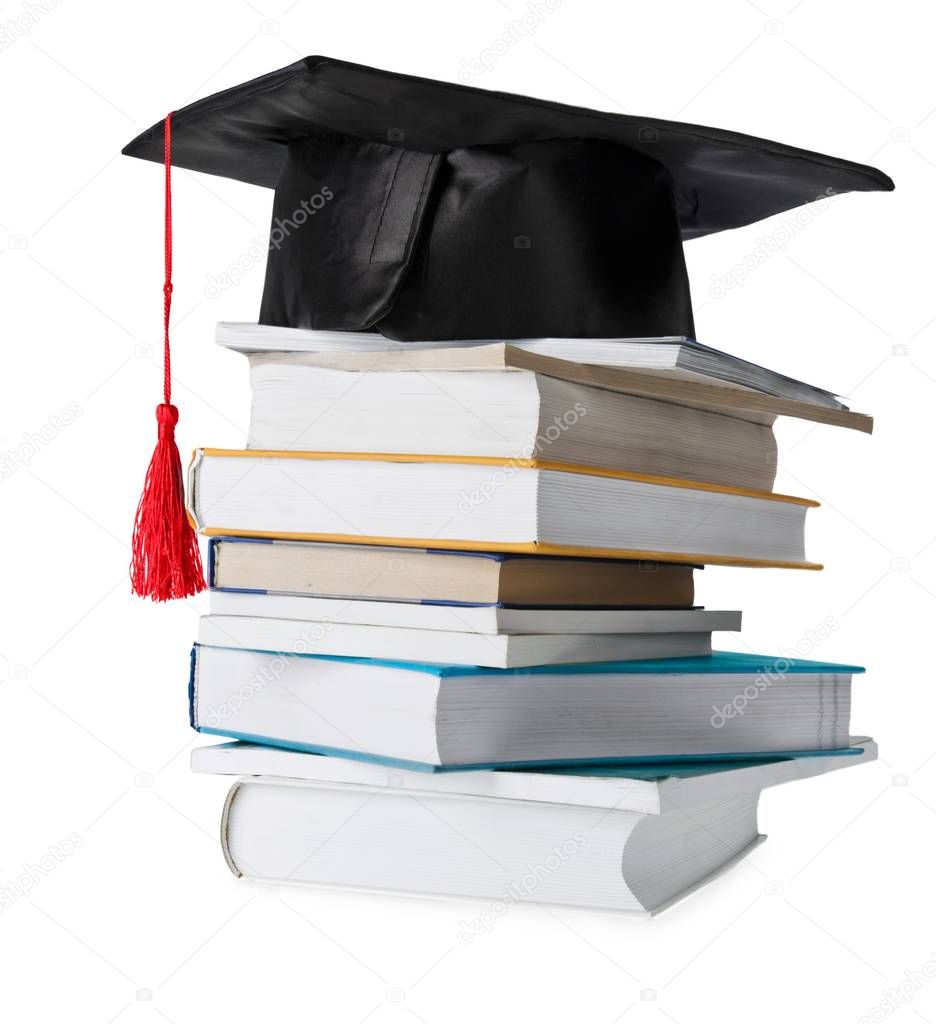 Graduation hat and stacks of books, close-up view 