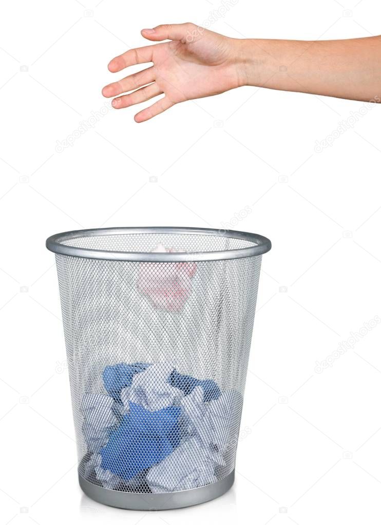 Hand throwing out paper into trashcan isolated on white background 