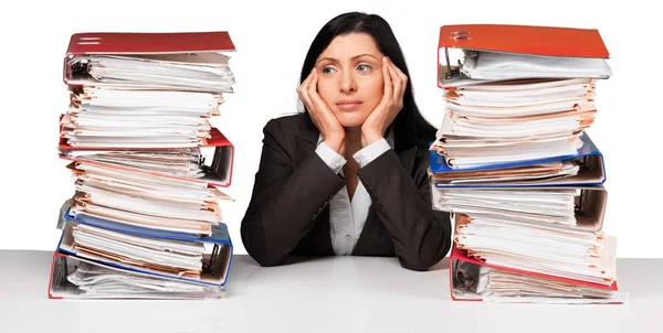 Business woman with stacks of documents — стоковое фото