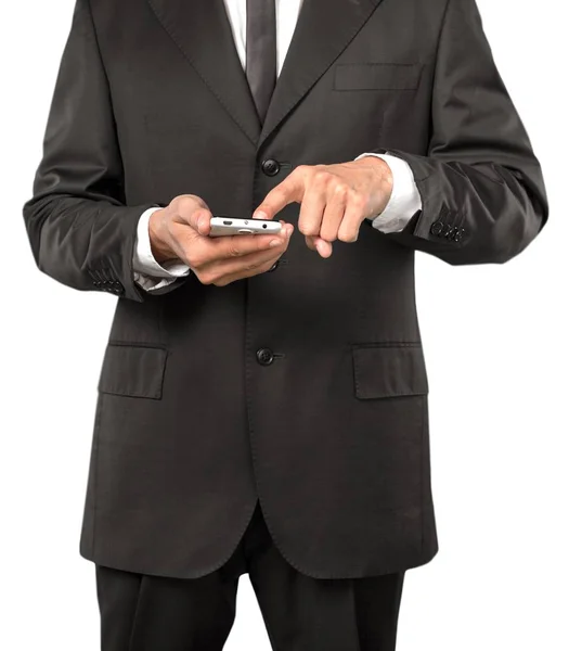 白い背景に分離された携帯を保持しているスーツのビジネスマン — ストック写真