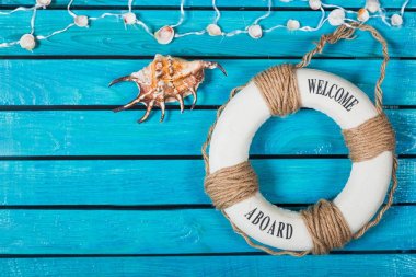 Seashell mavi ahşap zemin üzerinde. Seyahat kavramı