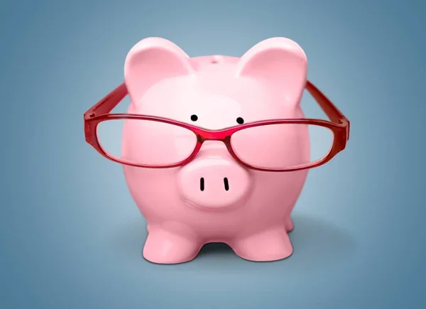 Piggy bank in glasses — Stock Photo, Image
