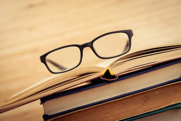 Heap of books with glasses