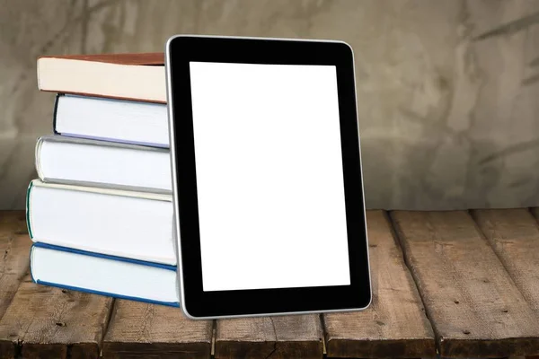 Pile of books with modern tablet PC — Stock Photo, Image