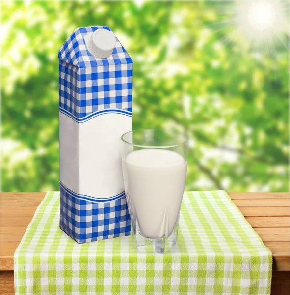 Milk in glass and box — Stock Photo, Image