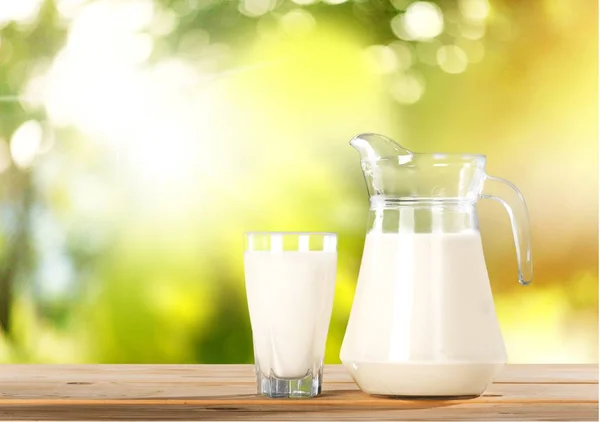 Glass of milk and jug — Stock Photo, Image