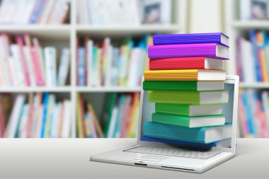 Dizüstü bilgisayar ile kitap yığını