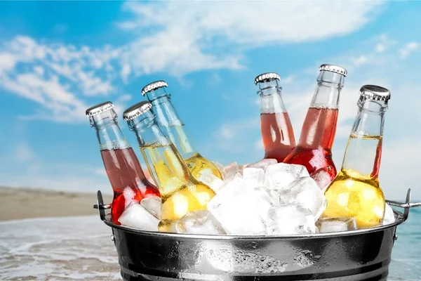 Beer bottles in ice — Stock Photo, Image