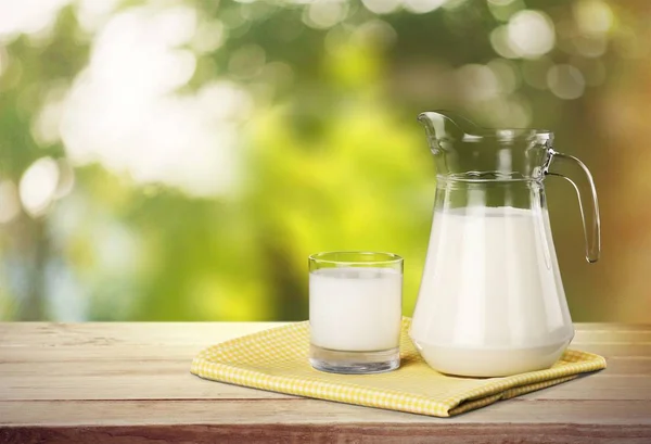 Glass of milk and jug — Stock Photo, Image