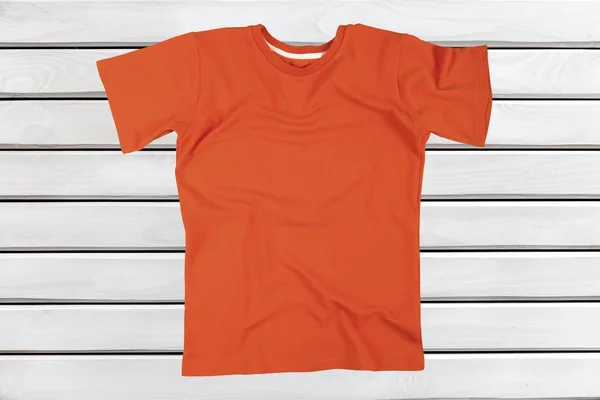 blank orange  t-shirt on wooden background