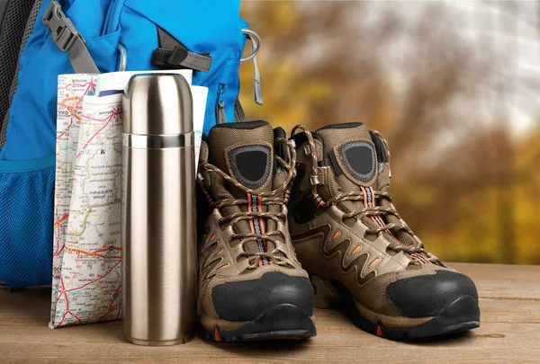 hiking boots, compass and map