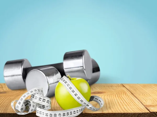 Dumbbells with measuring tape — Stock Photo, Image