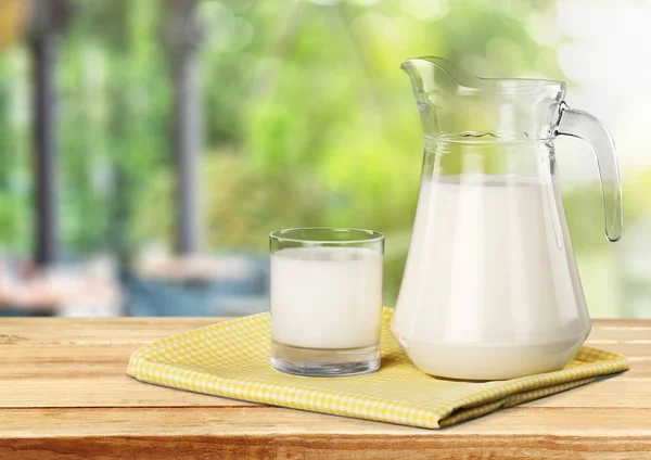 Glass of milk and jug — Stock Photo, Image