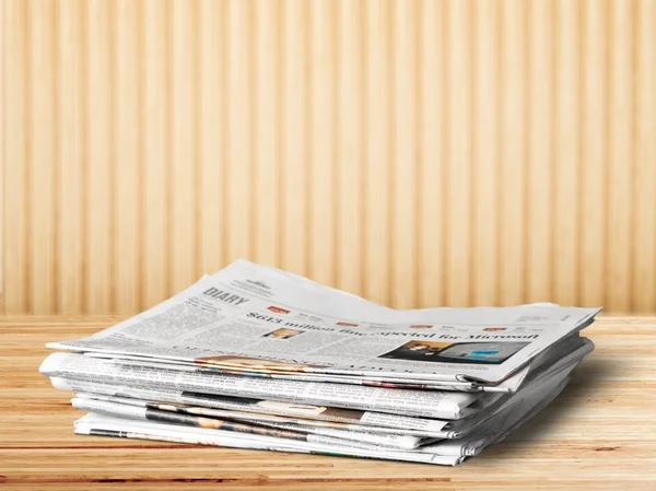 Pile of printed newspapers on background