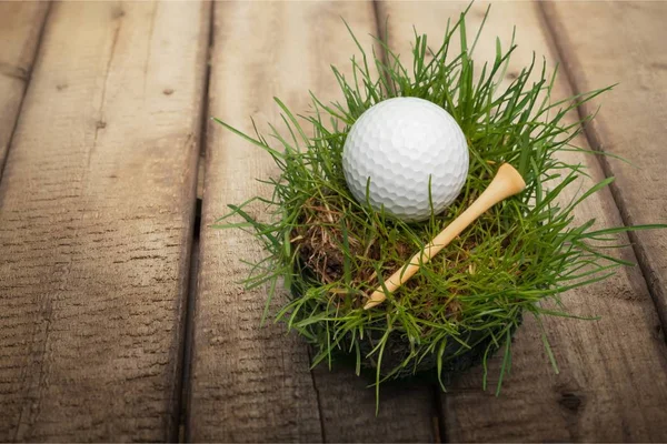 golf ball and tee on background