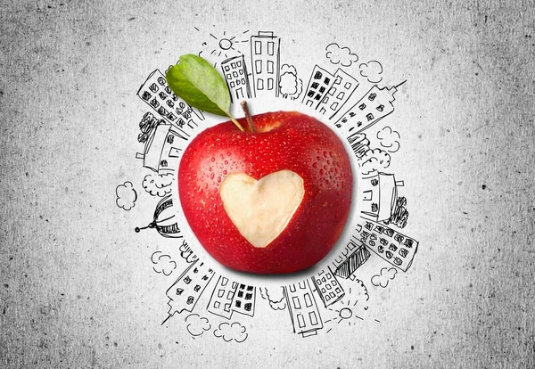 Apple with carved heart sign on sketch background
