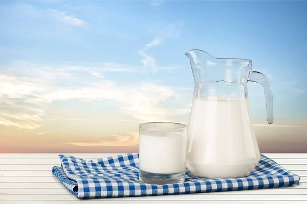 Glass of milk and jug — Stock Photo, Image