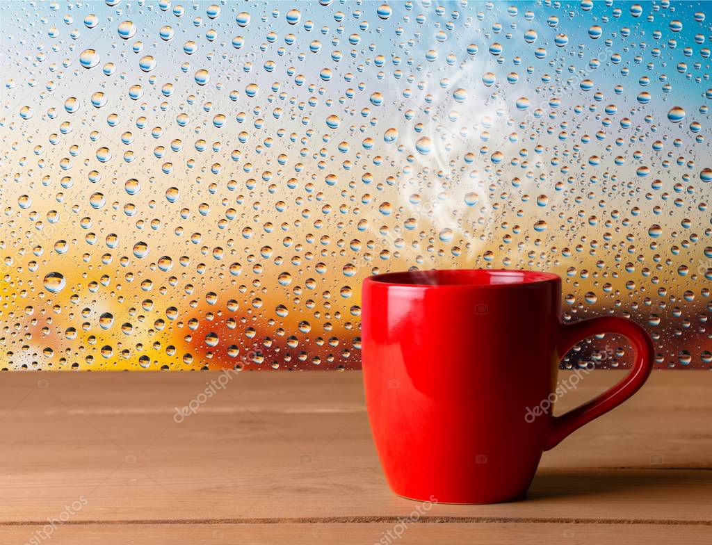 Red ceramic cup on wooden background