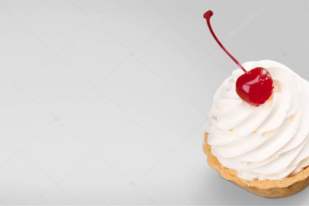 Cherry dessert with cream isolated on white background
