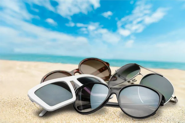 Many Sunglasses Sand Background Travel Concept — Stock Photo, Image