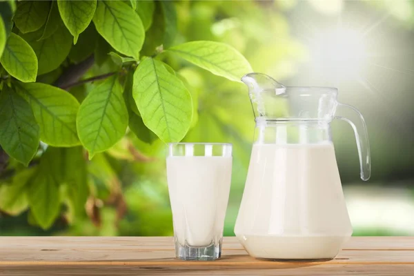 Glass of milk and jug — Stock Photo, Image