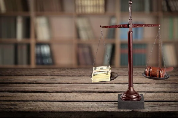 Justice Scales with money and wooden gavel