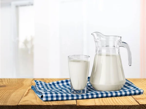 Glass of milk and jug — Stock Photo, Image