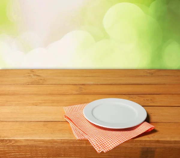Белая тарелка на салфетке — стоковое фото