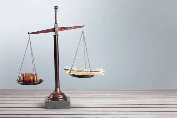 Justice Scales with money and wooden gavel