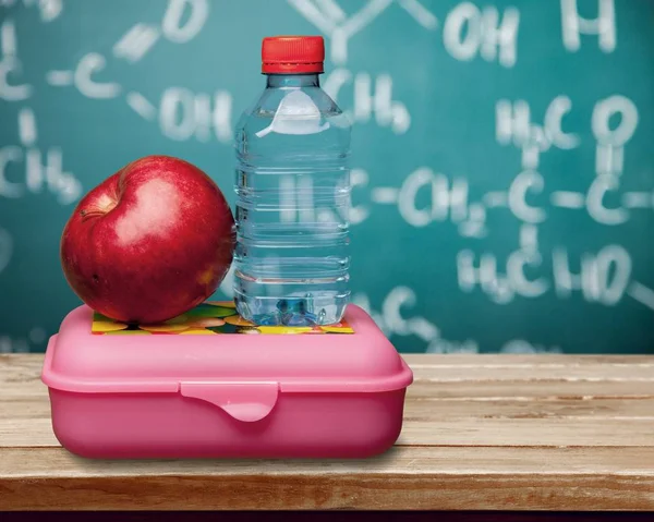 Red apple with water and food — Stock Photo, Image