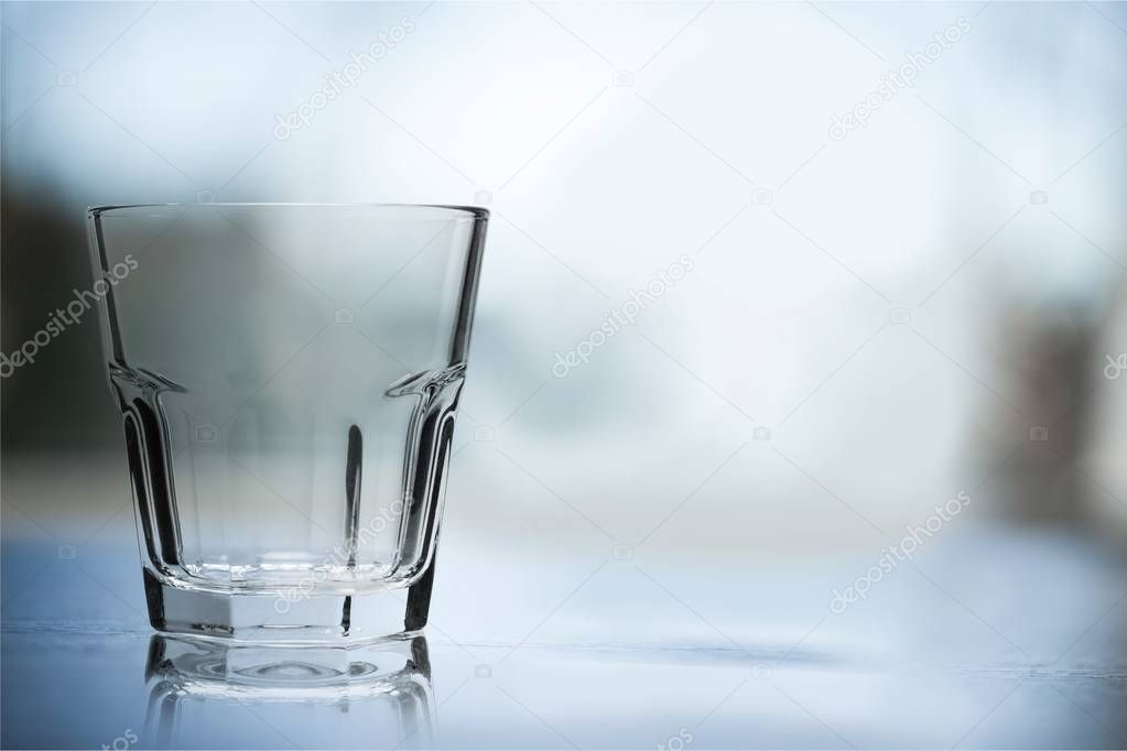 empty glass on table on light background 