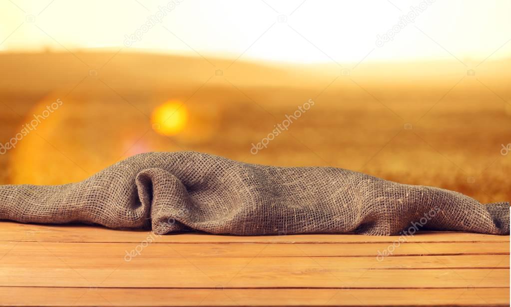 Empty wooden surface on sunset background 