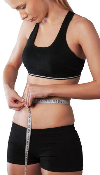 Jovem mulher medindo sua cintura — Fotografia de Stock