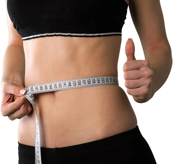 Young woman measuring her waist — Stock Photo, Image