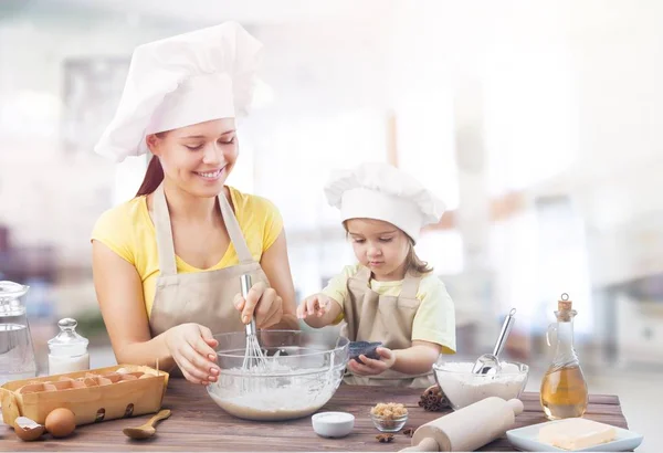 Meisje en haar moeder samen bakken — Stockfoto