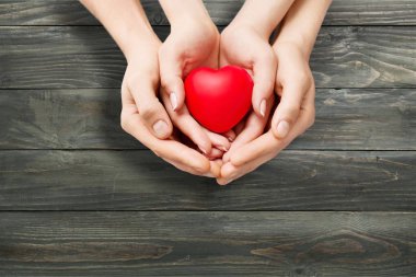 Man and woman holding red heart  clipart